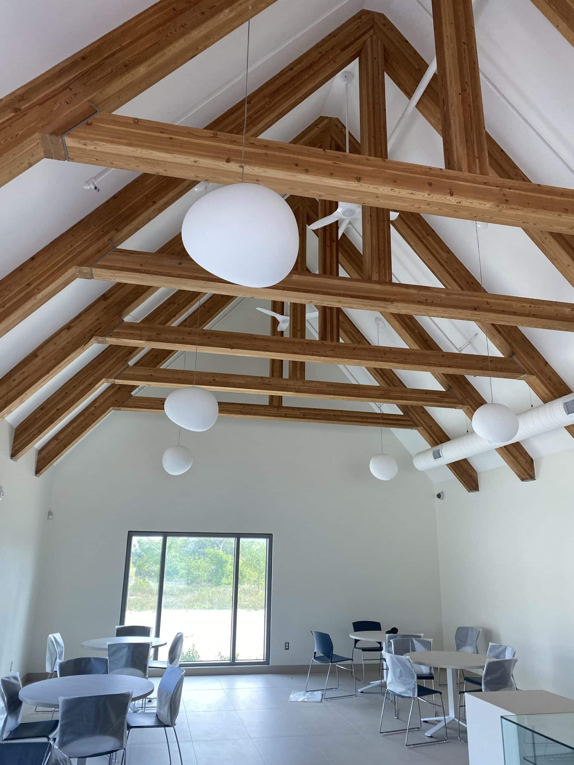 Interior room at the Poinciana Rehabilitation Centre featuring a large glass door and high ceiling.